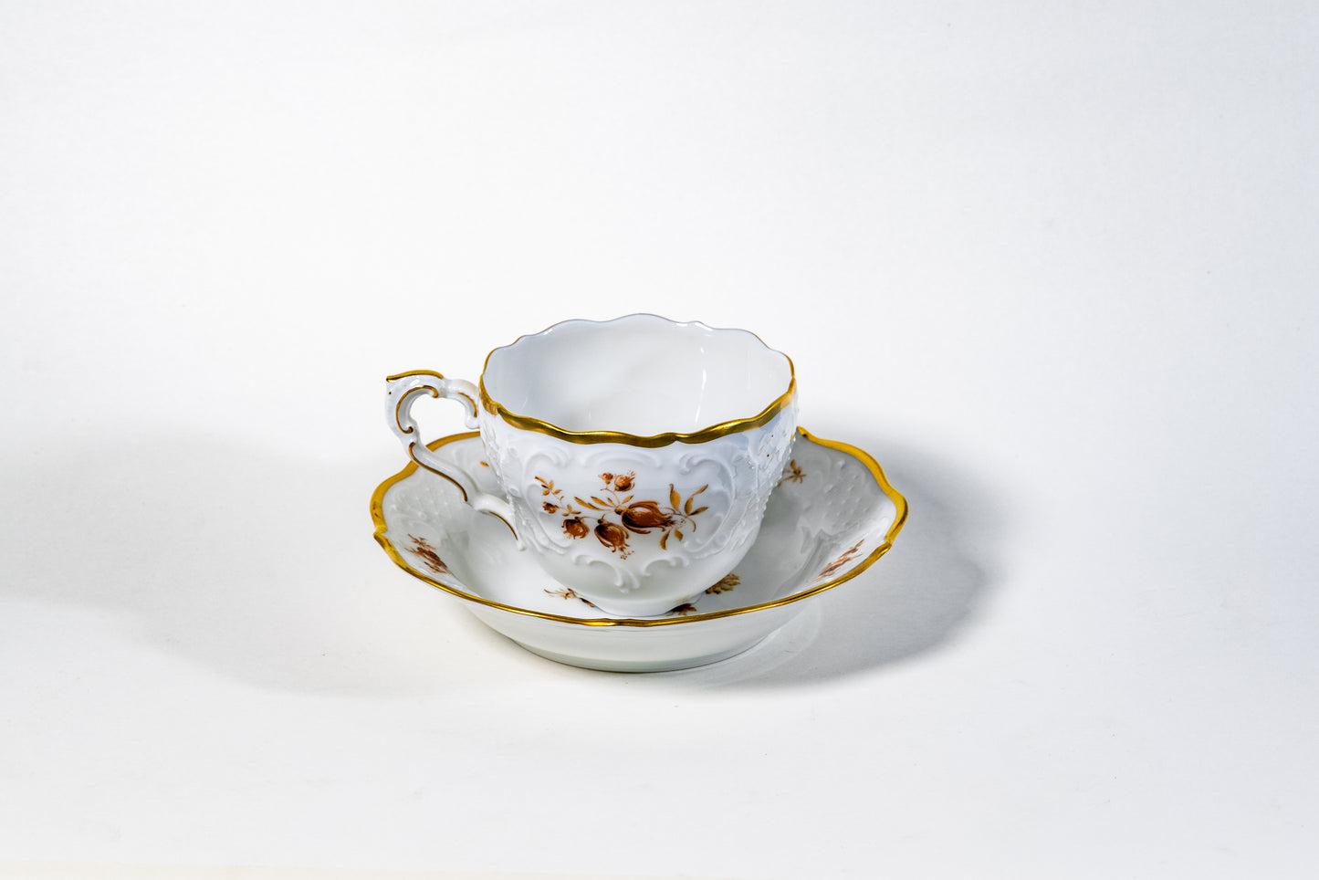 German Lindner Rococo-Style Coffee Cup – 22k Gilded Relief with Brown Floral Accents