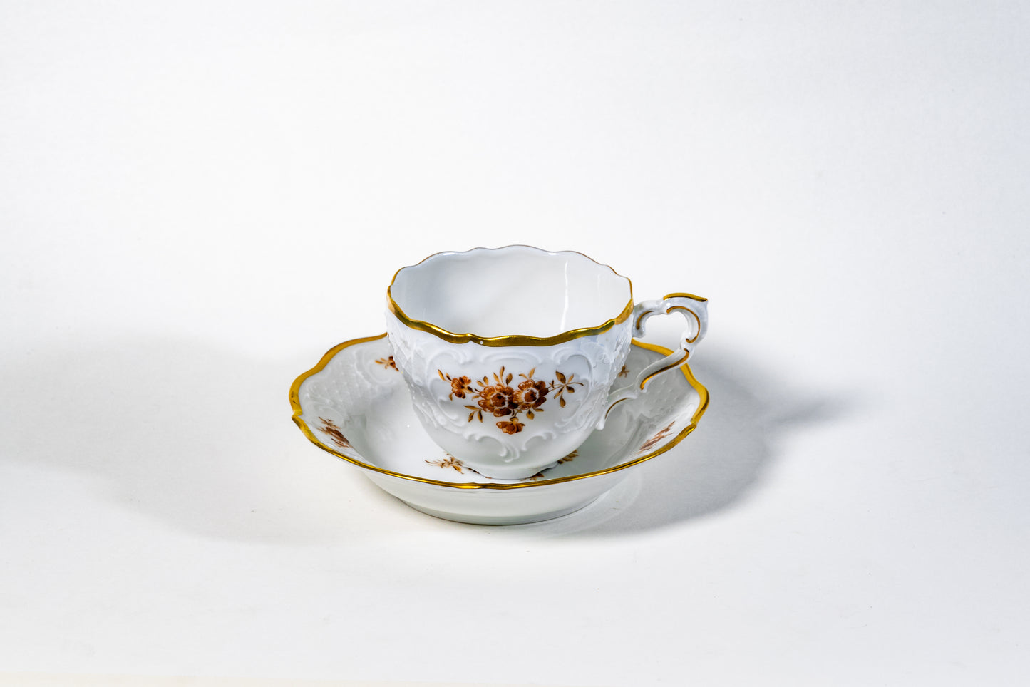 German Lindner Rococo-Style Coffee Cup – 22k Gilded Relief with Brown Floral Accents